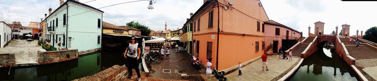 Panoramic view of canal amidst buildings in town