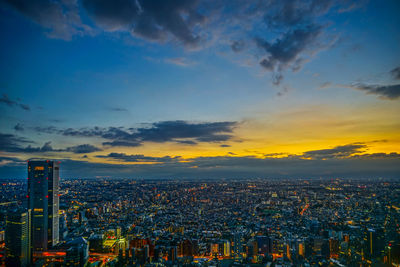 Aerial view of cityscape against sky during sunset