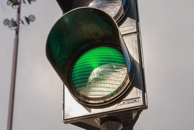 Low angle view of road signal against clear sky