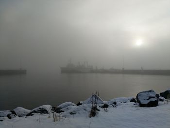 Scenic view of snow covered lake against sky