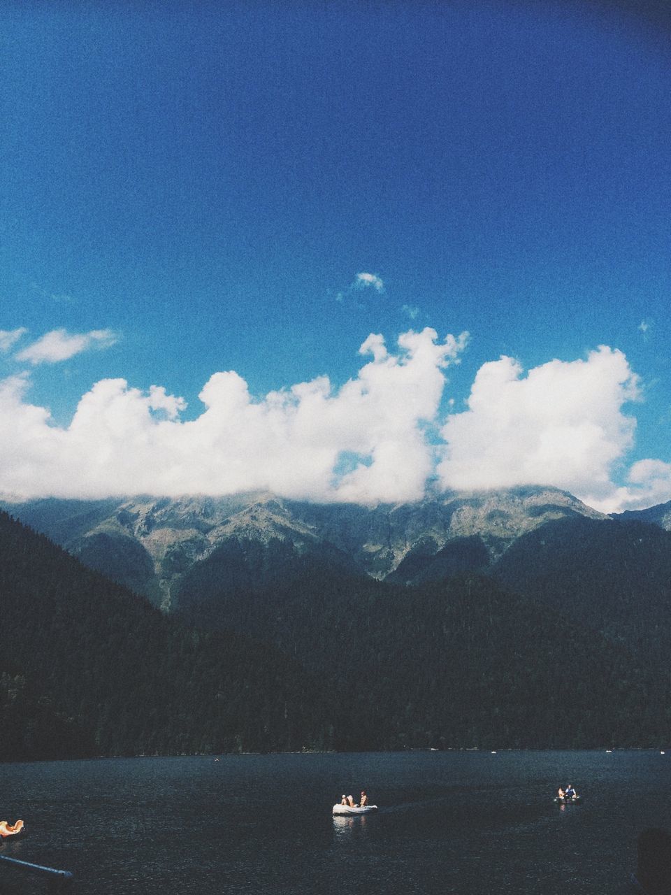 mountain, water, nautical vessel, waterfront, transportation, scenics, mountain range, tranquil scene, mode of transport, sea, tranquility, sky, beauty in nature, boat, nature, blue, cloud - sky, idyllic, travel, cloud