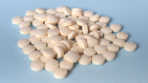 High angle view of pills on blue background