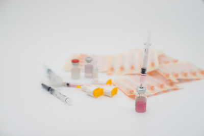 Close-up of medical supplies against white background