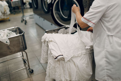 Midsection of man holding suitcase