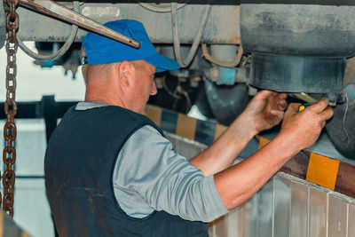 Rear view of man working in workshop