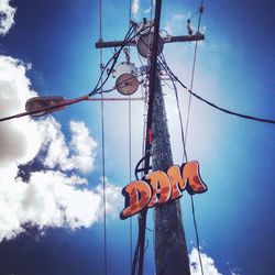 Low angle view of power lines against cloudy sky