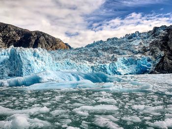 Scenic view of glaciers and ice in sea against sky