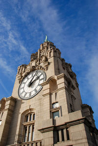 Low angle view of clock tower against sky