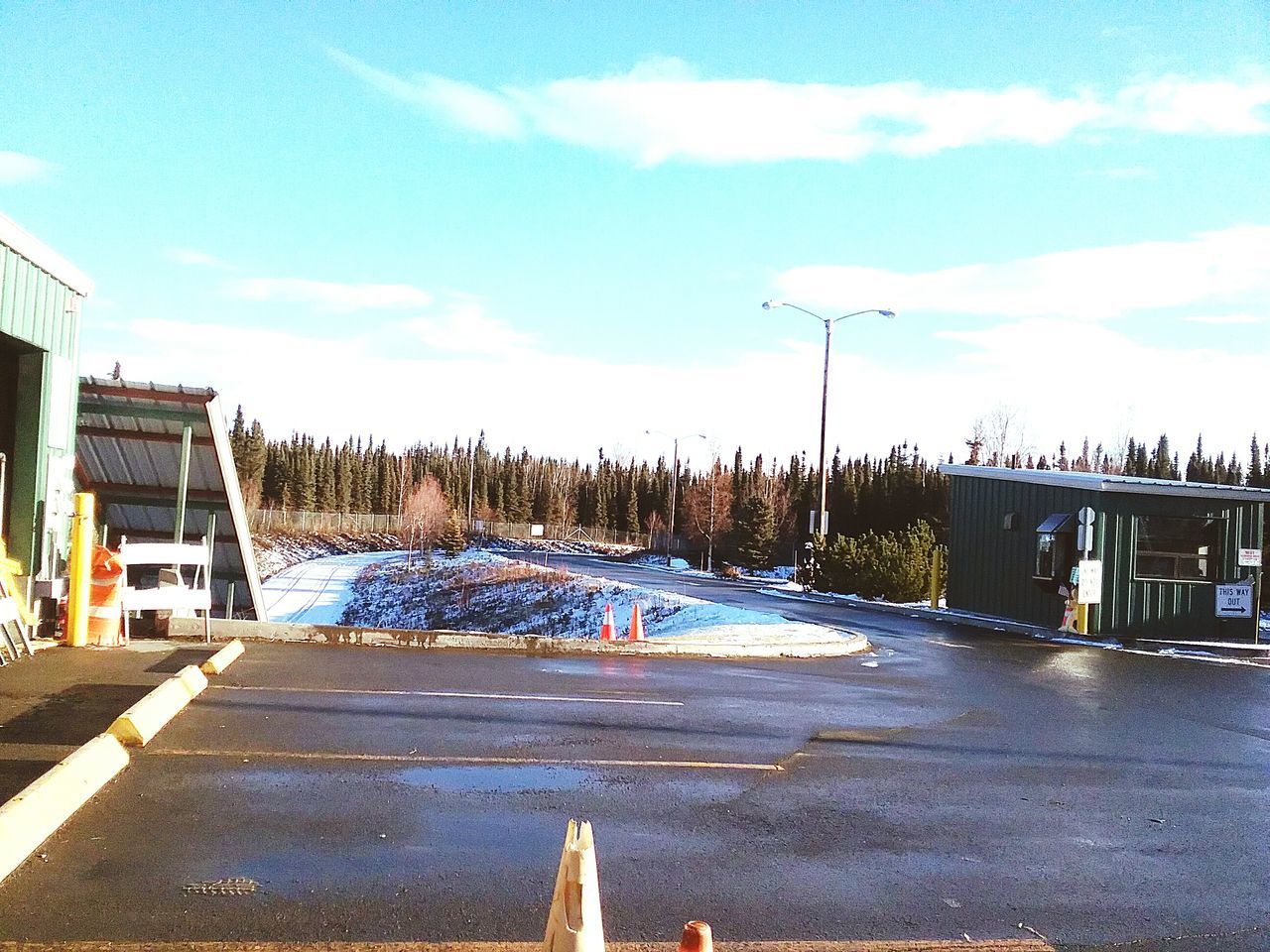 RAILROAD TRACK BY ROAD AGAINST SKY