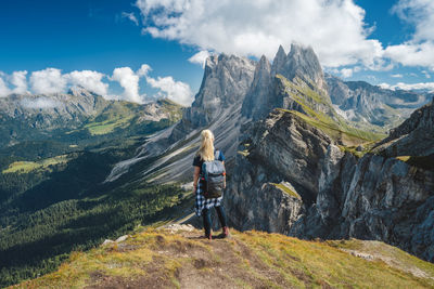 Woman standing on mountain against sky