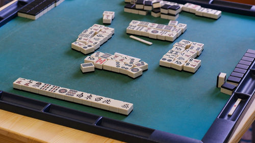 Many mahjong tiles on the playing field. an ancient asian game called mahjong