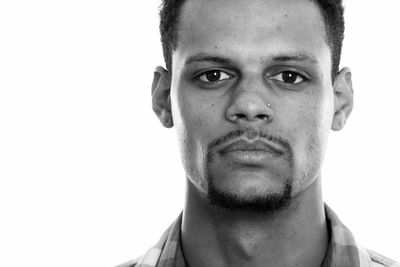 Close-up portrait of young man against white background