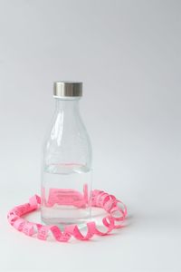 Close-up of wine glass on table against white background