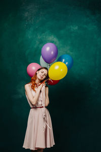 Woman holding colorful balloons