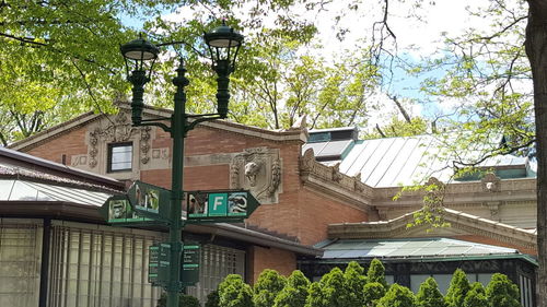 Low angle view of street light by building