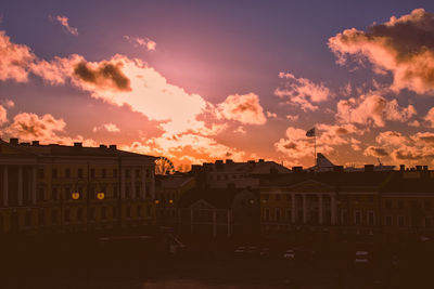 Residential district against sky during sunset