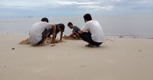 Rear view of people on beach