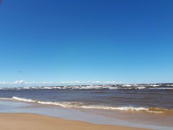 Scenic view of sea against clear blue sky