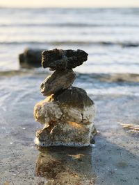 Stack of stones on shore at beach