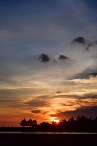 Scenic view of silhouette trees against sky at sunset