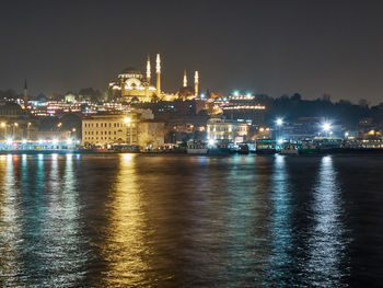 Suleymaniye mosque and golden horn bay lights reflections in the evening.