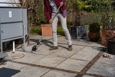 Low section of man standing on footpath