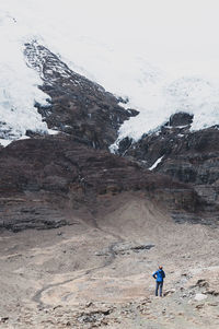 Full length of person on snow covered mountain