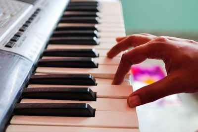 Close-up of hands playing piano