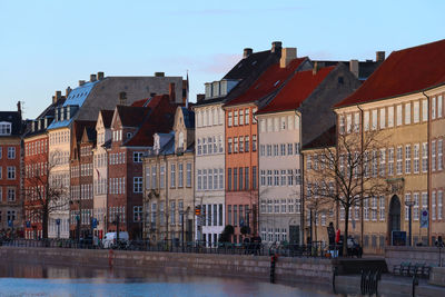 Buildings in city against clear sky