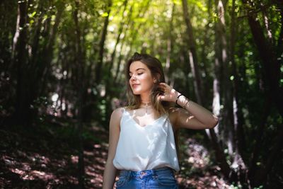 Portrait of smiling young woman in forest