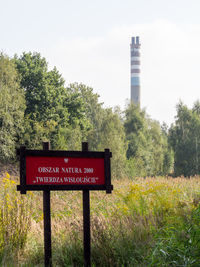 Low angle view of information sign on tree