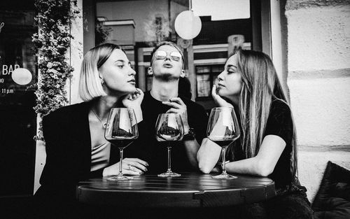 Cheerful friends sitting at restaurant