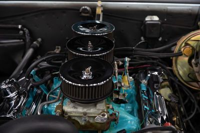 Close-up of vintage car motor with tri power carburetors 