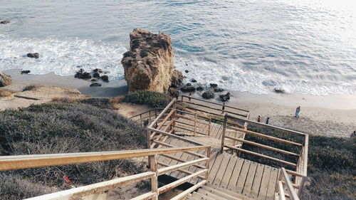 Stairs leading to calm shore