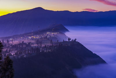 Low clouds at cemoro lawang village at sunrise at bromo tengger semeru national park,