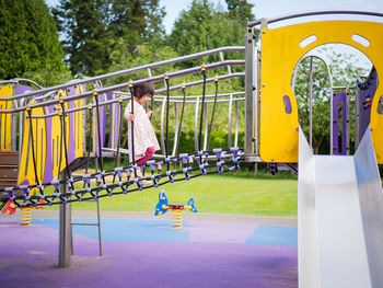 Full length of cute girl playing in playground