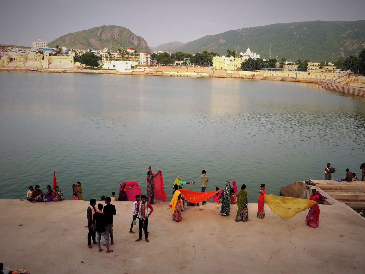 HIGH ANGLE VIEW OF PEOPLE AT BEACH AGAINST SKY