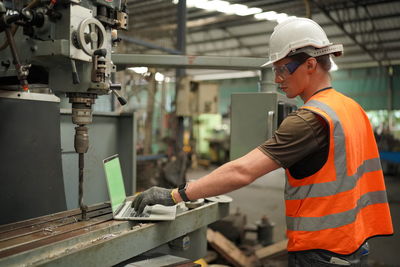 Portrait of male worker standing in the heavy industry manufacturing factory.