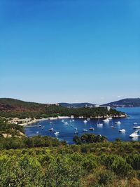 Scenic view of lake against clear blue sky