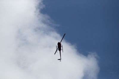 Low angle view of silhouette person paragliding against sky