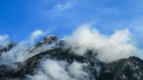 Scenic view of mountains against cloudy sky