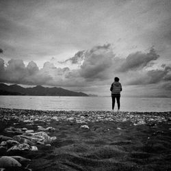 Rear view of man standing on beach