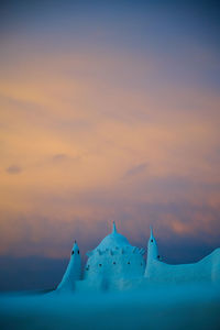 Lighthouse against sky during sunset