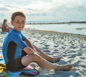 Portrait of boy sitting at beach