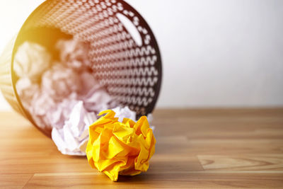 Close-up of yellow paper on table