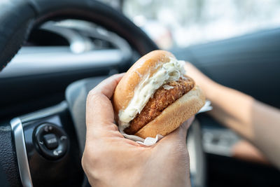 Cropped hand of man holding food