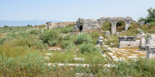 Old ruins on field against sky