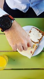 Close-up of man holding ice cream in plate