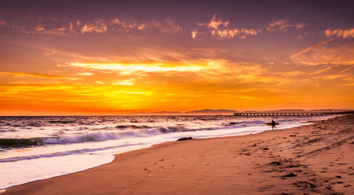 Scenic view of beach against sky during sunset