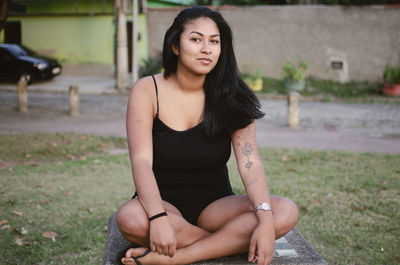 Portrait of young woman sitting outdoors